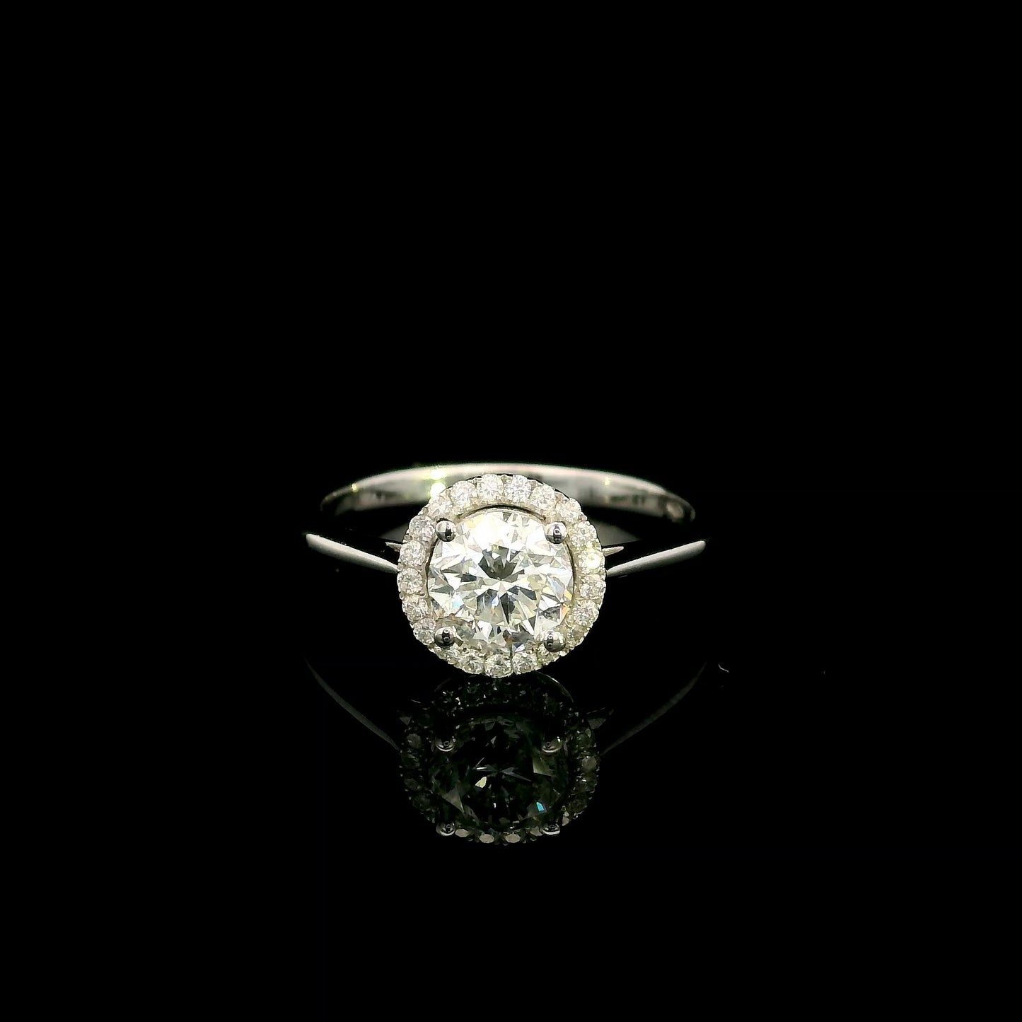 18K white gold round diamond halo engagement ring with a 0.98 carat IGI certified centre diamond and sparkling diamond halo.