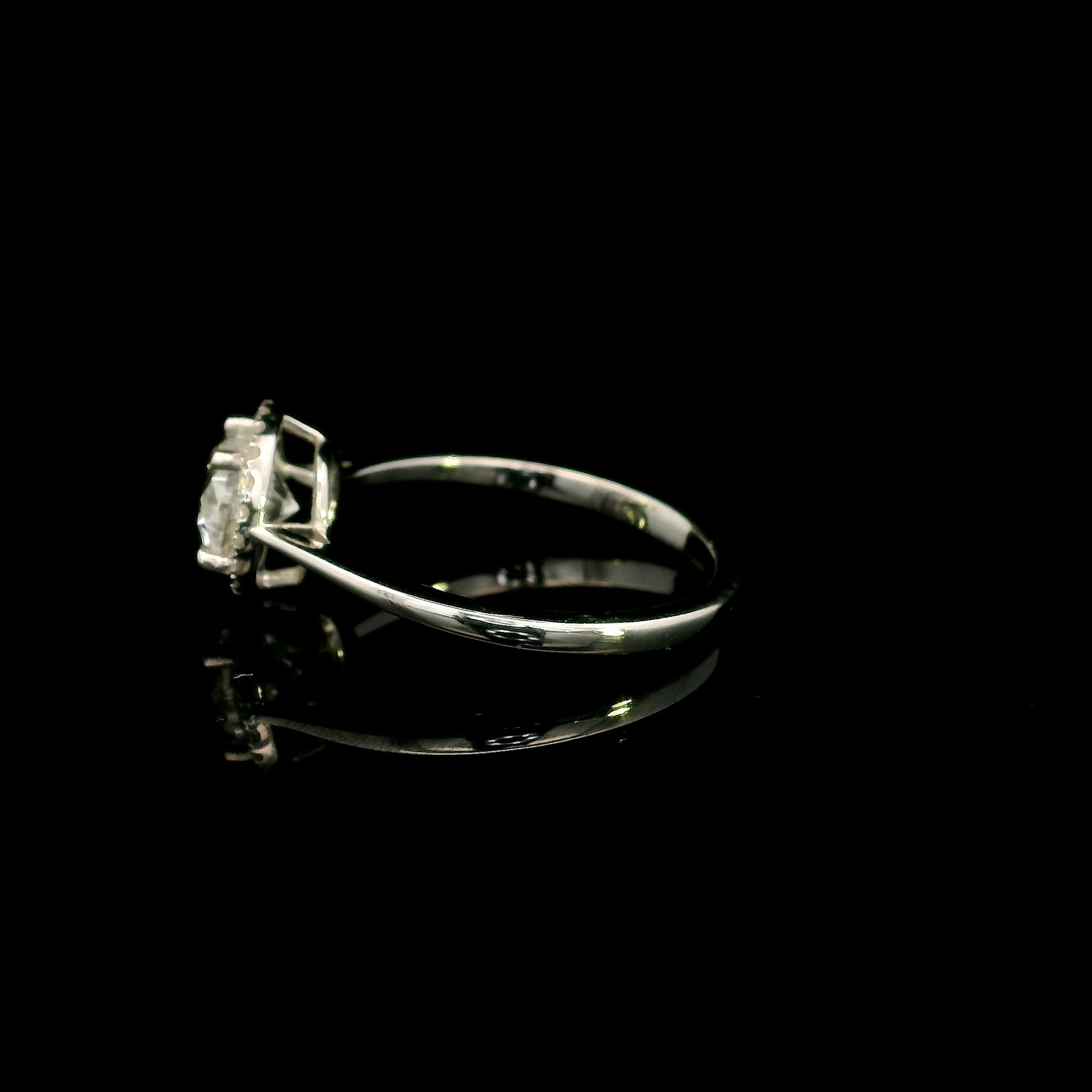 18K white gold round diamond halo engagement ring with a 0.98 carat IGI certified centre diamond and sparkling diamond halo.
