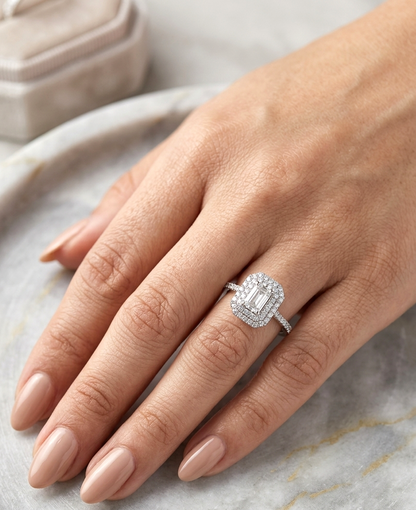 18K white gold halo engagement ring featuring a 1.00 carat GIA certified natural emerald cut diamond with VVS2 clarity and E colour, surrounded by a double halo and 0.43 carat natural round brilliant diamonds.