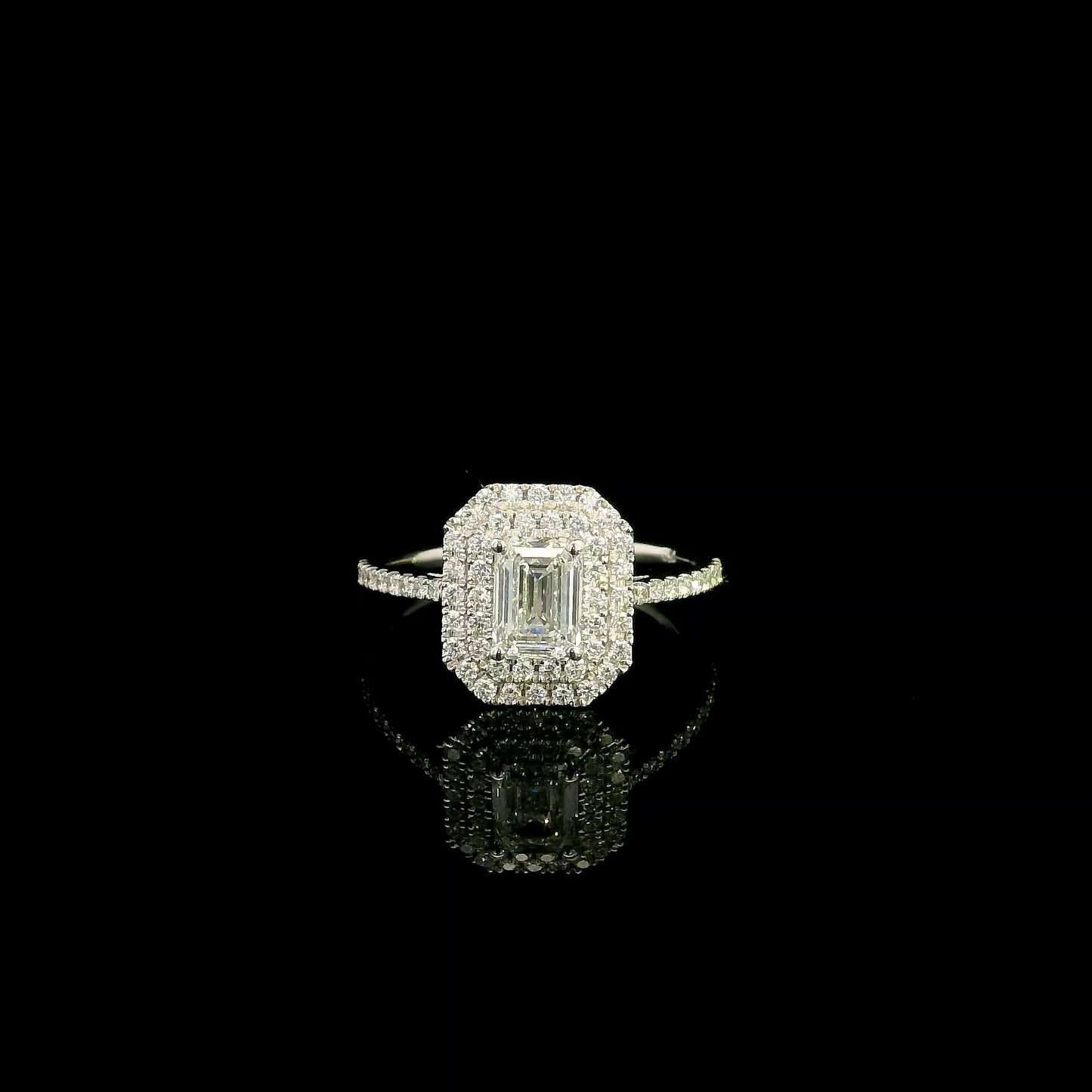 18K white gold halo engagement ring featuring a 1.00 carat GIA certified natural emerald cut diamond with VVS2 clarity and E colour, surrounded by a double halo and 0.43 carat natural round brilliant diamonds.