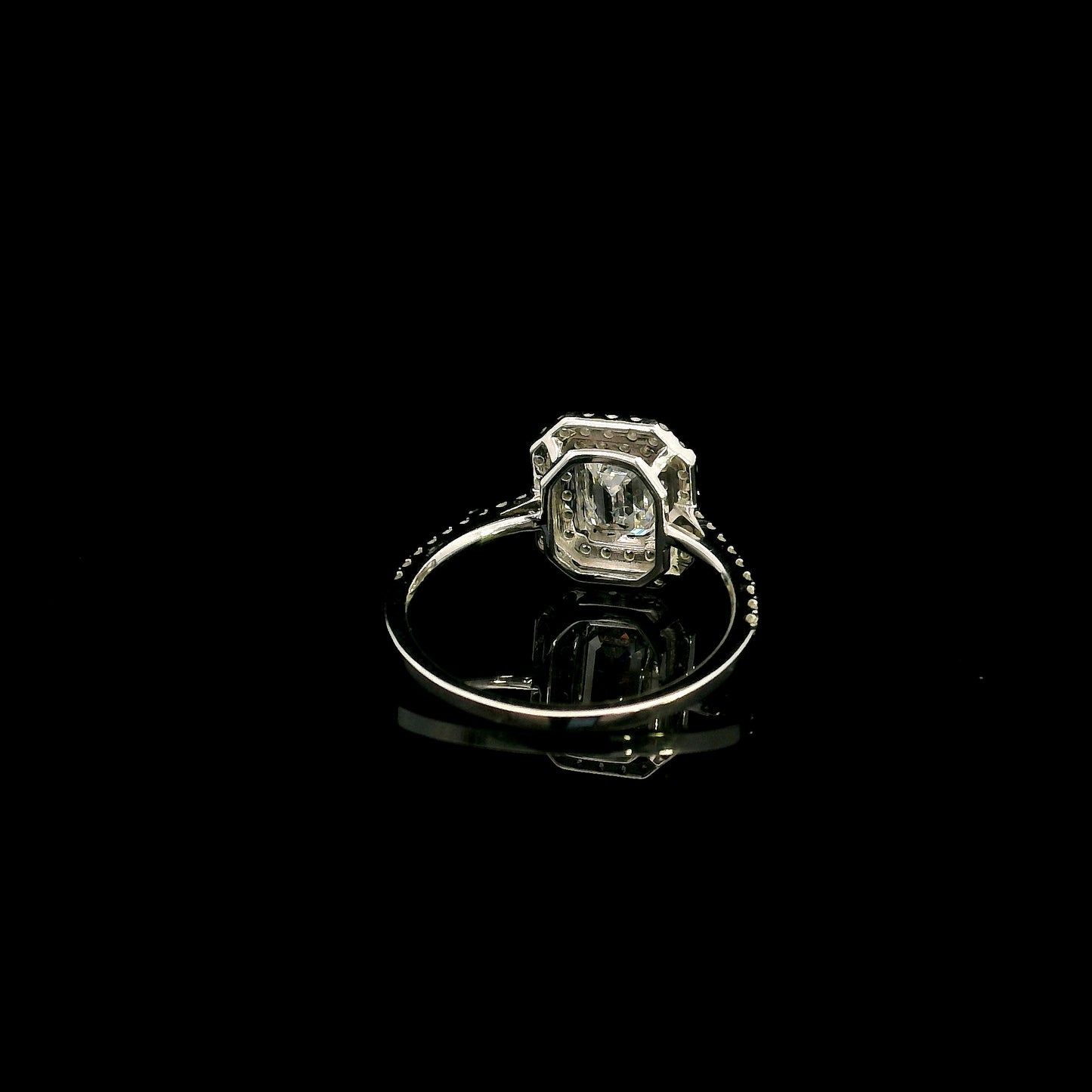 18K white gold halo engagement ring featuring a 1.00 carat GIA certified natural emerald cut diamond with VVS2 clarity and E colour, surrounded by a double halo and 0.43 carat natural round brilliant diamonds.