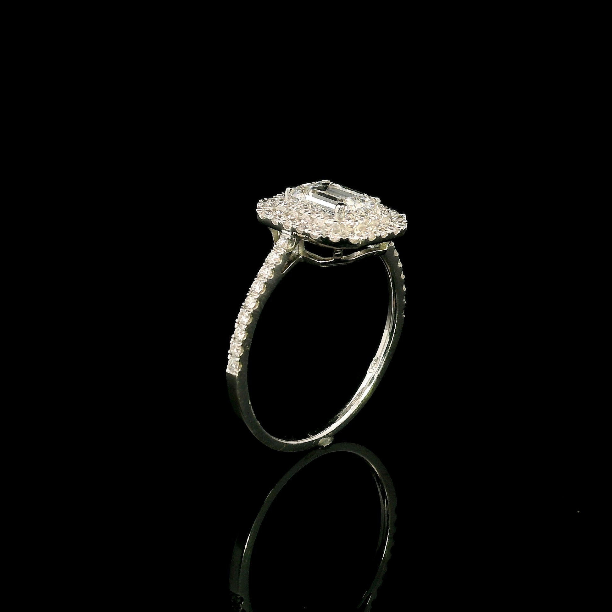 18K white gold halo engagement ring featuring a 1.00 carat GIA certified natural emerald cut diamond with VVS2 clarity and E colour, surrounded by a double halo and 0.43 carat natural round brilliant diamonds.