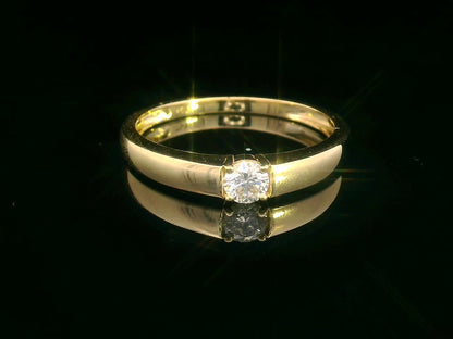 Tapered 18K yellow gold solitaire ring with a 0.30 carat round diamond in a sleek four-prong setting.