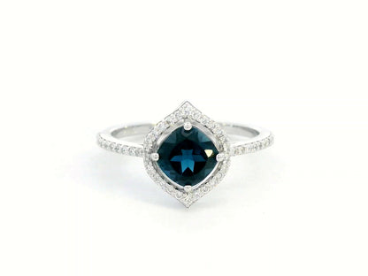 Cushion-cut London Blue Topaz ring with diamond halo and pavé diamond band in 18K gold


