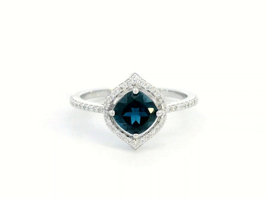 Cushion-cut London Blue Topaz ring with diamond halo and pavé diamond band in 18K gold

