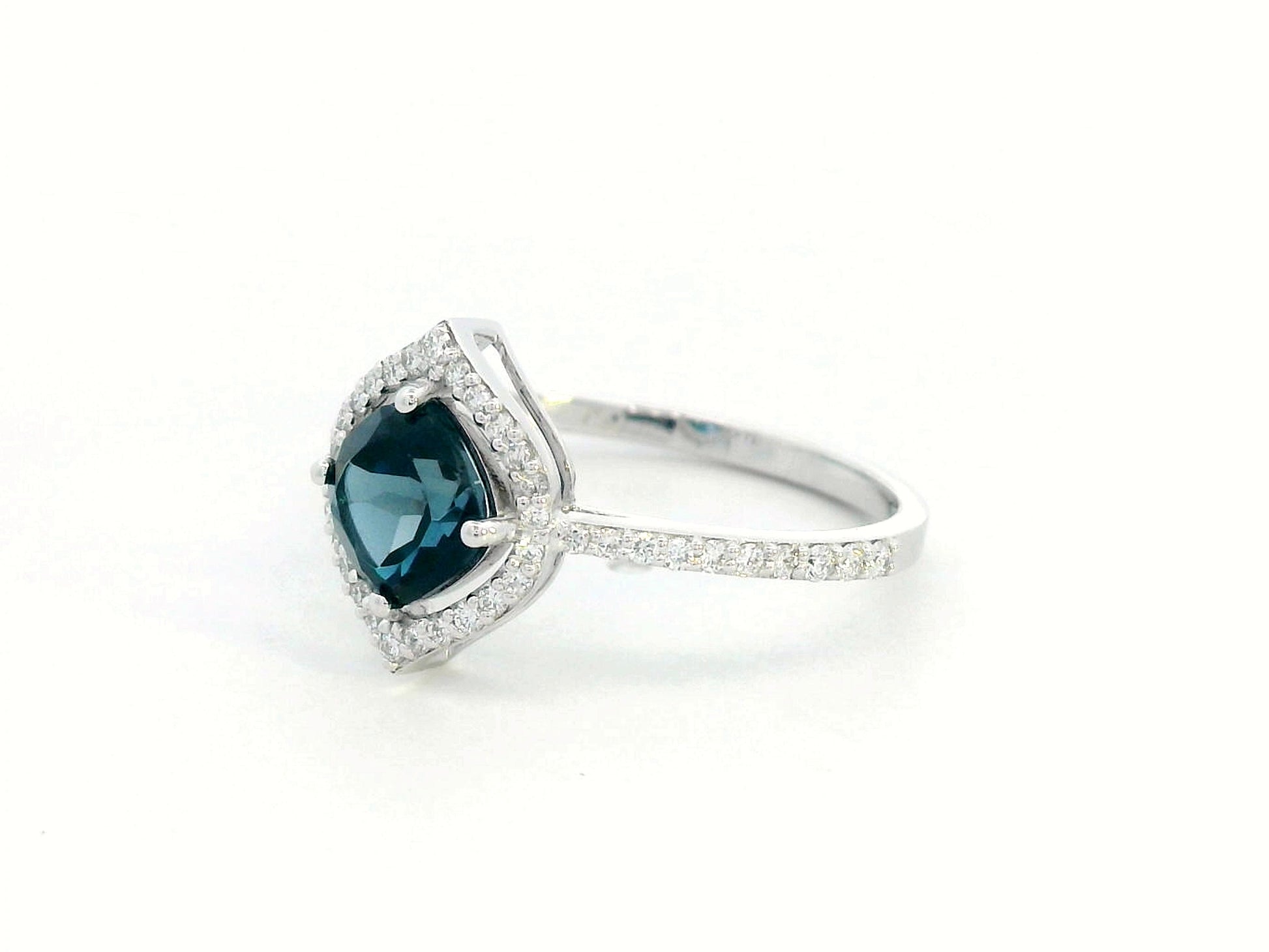 Cushion-cut London Blue Topaz ring with diamond halo and pavé diamond band in 18K gold

