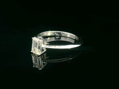 0.91 carat emerald cut diamond solitaire ring with knife-edge 18K gold band, minimalist and elegant design.