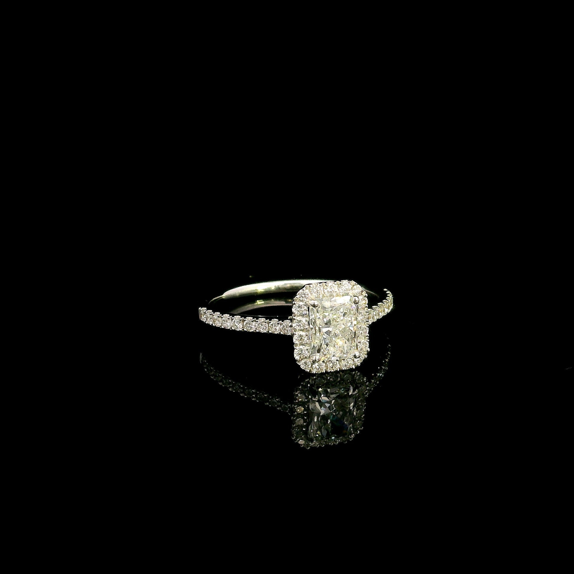 18K white gold radiant cut diamond halo engagement ring featuring a 1.01 carat GIA certified natural diamond with a diamond halo and pavé band.