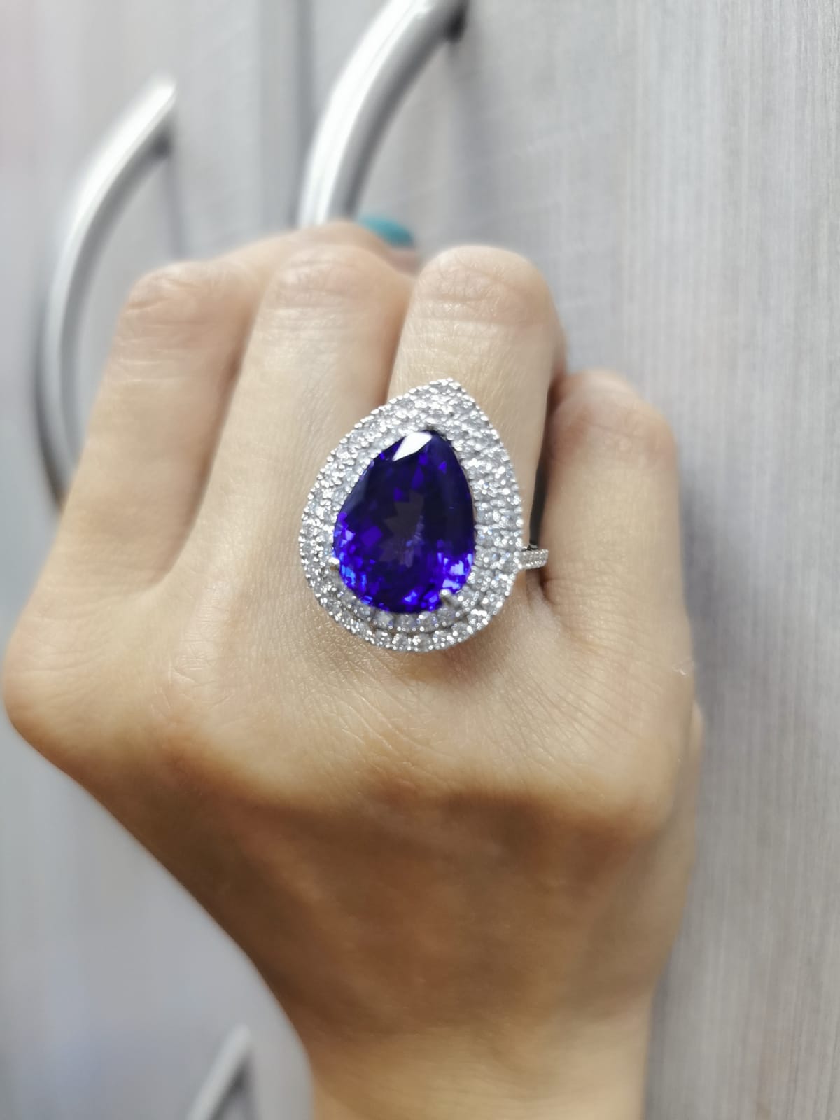 Pear-shaped tanzanite cocktail ring with double diamond halo in 18K gold