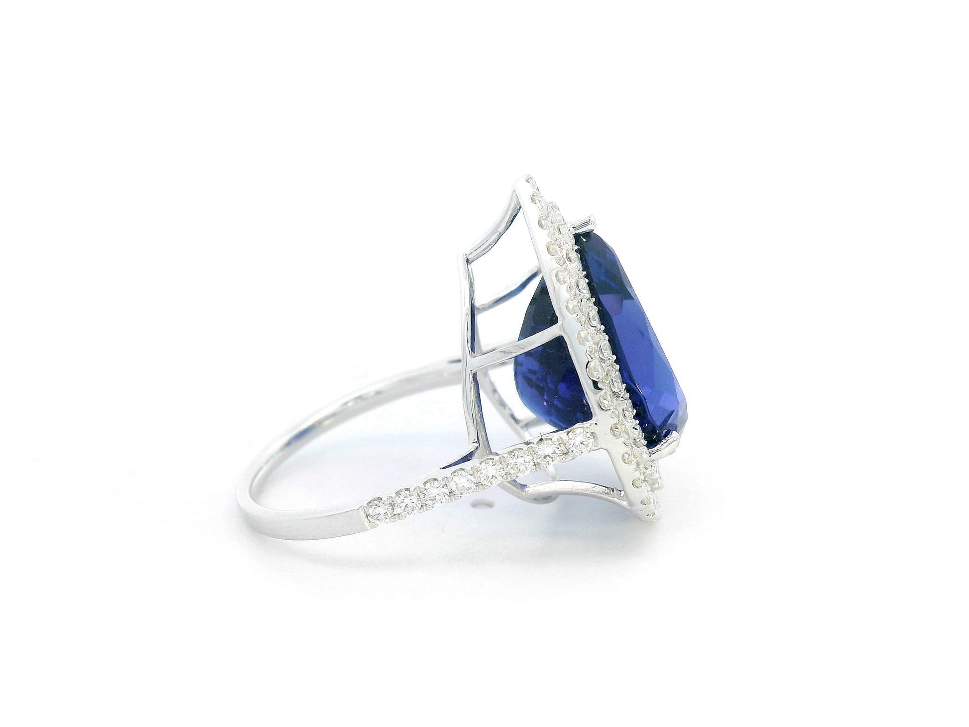 Pear-shaped tanzanite cocktail ring with double diamond halo in 18K gold
