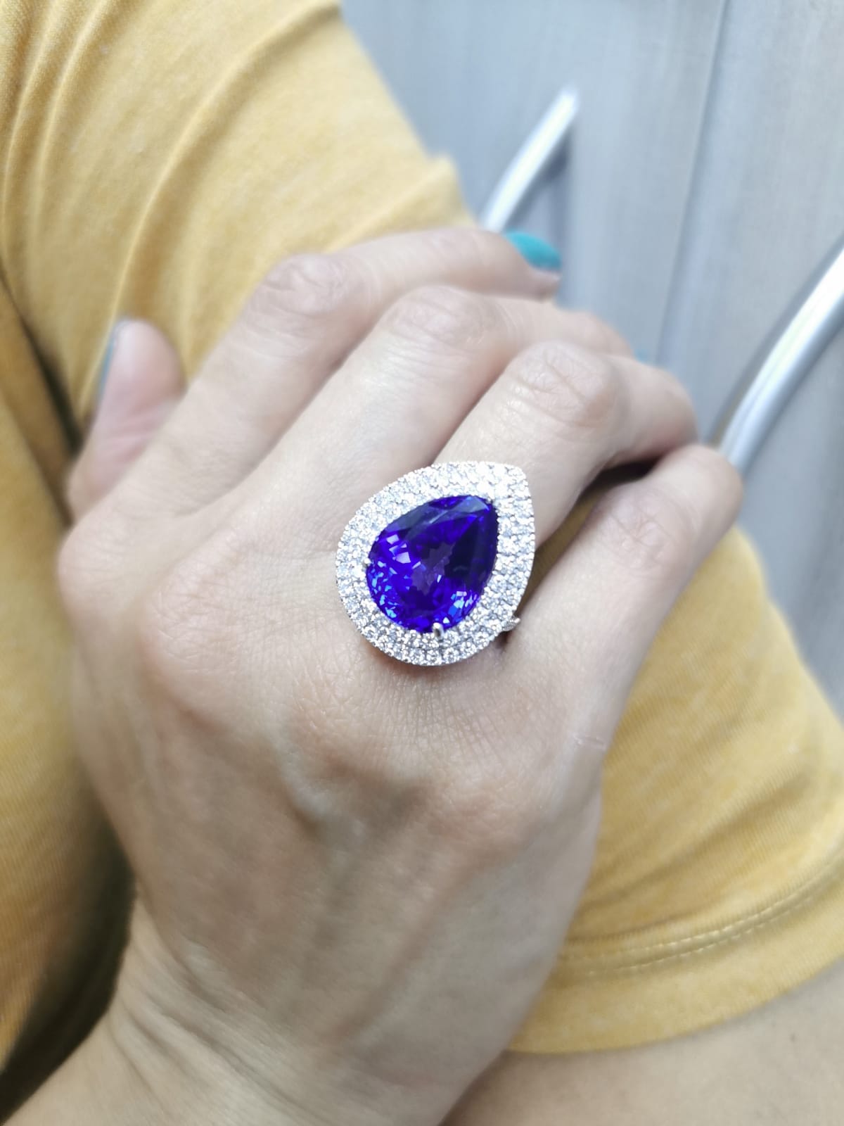 Pear-shaped tanzanite cocktail ring with double diamond halo in 18K gold