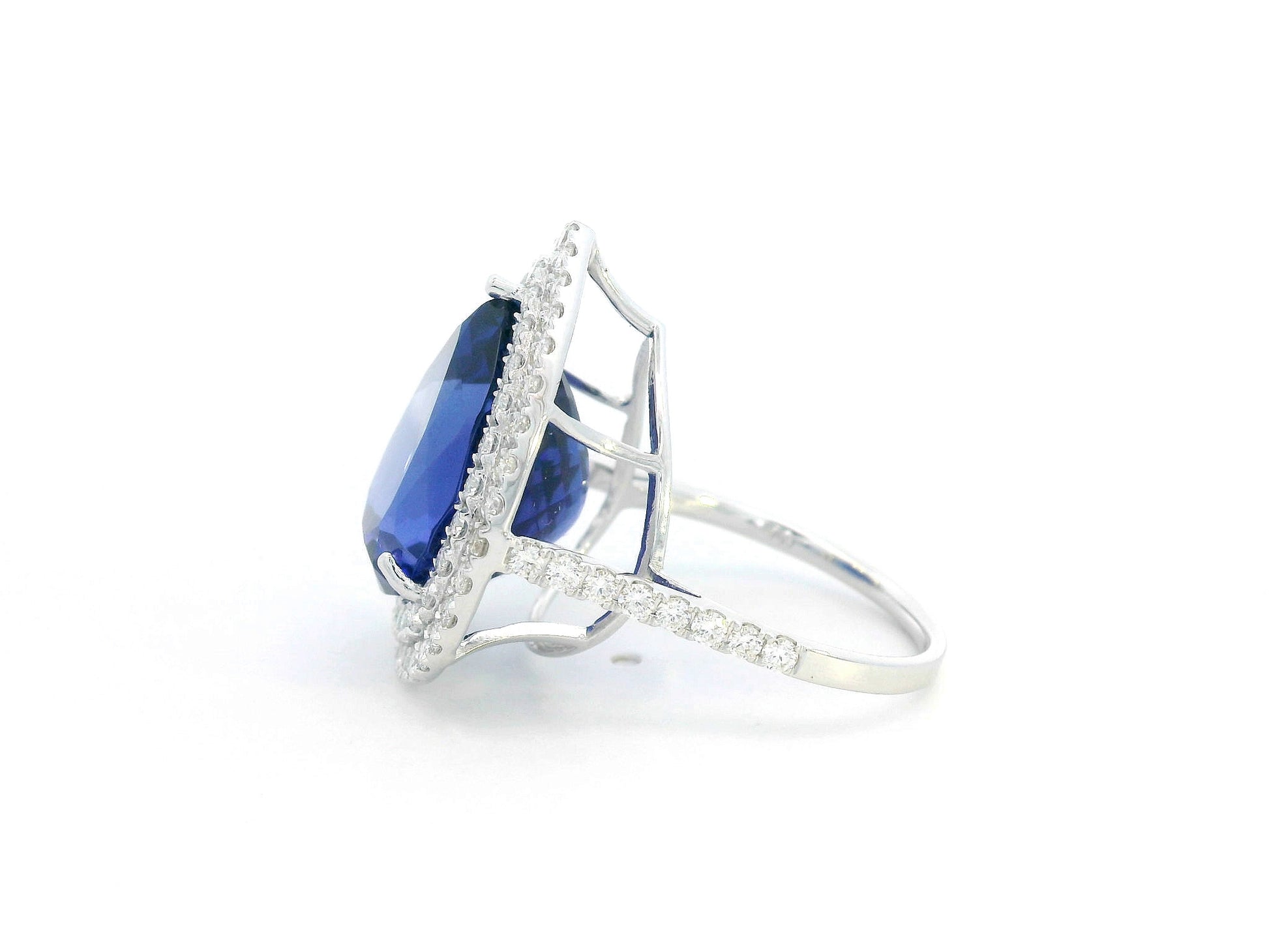 Pear-shaped tanzanite cocktail ring with double diamond halo in 18K gold