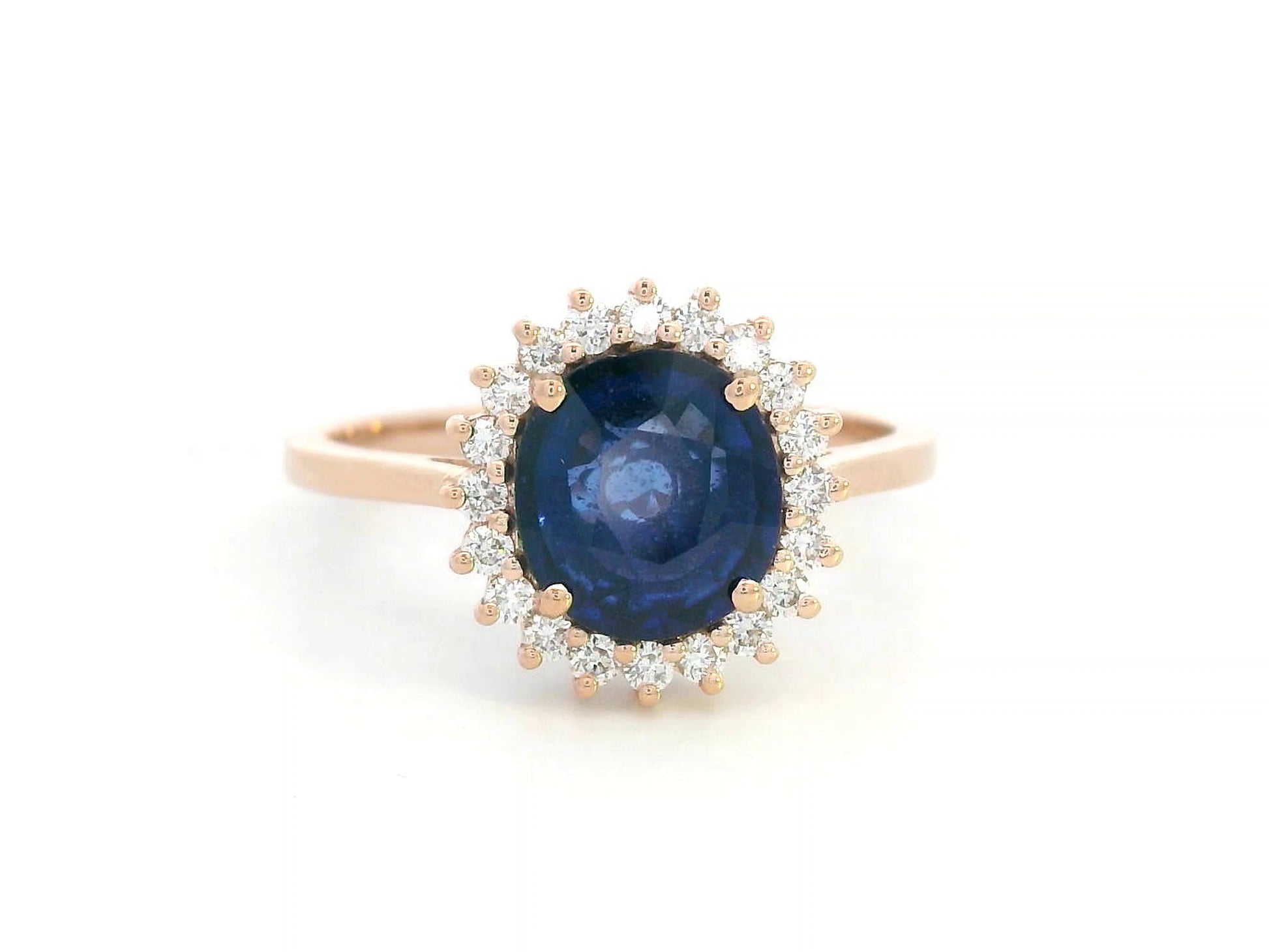 Blue sapphire and diamond halo ring in 18K rose gold with 2.02 carat sapphire and vintage-inspired setting