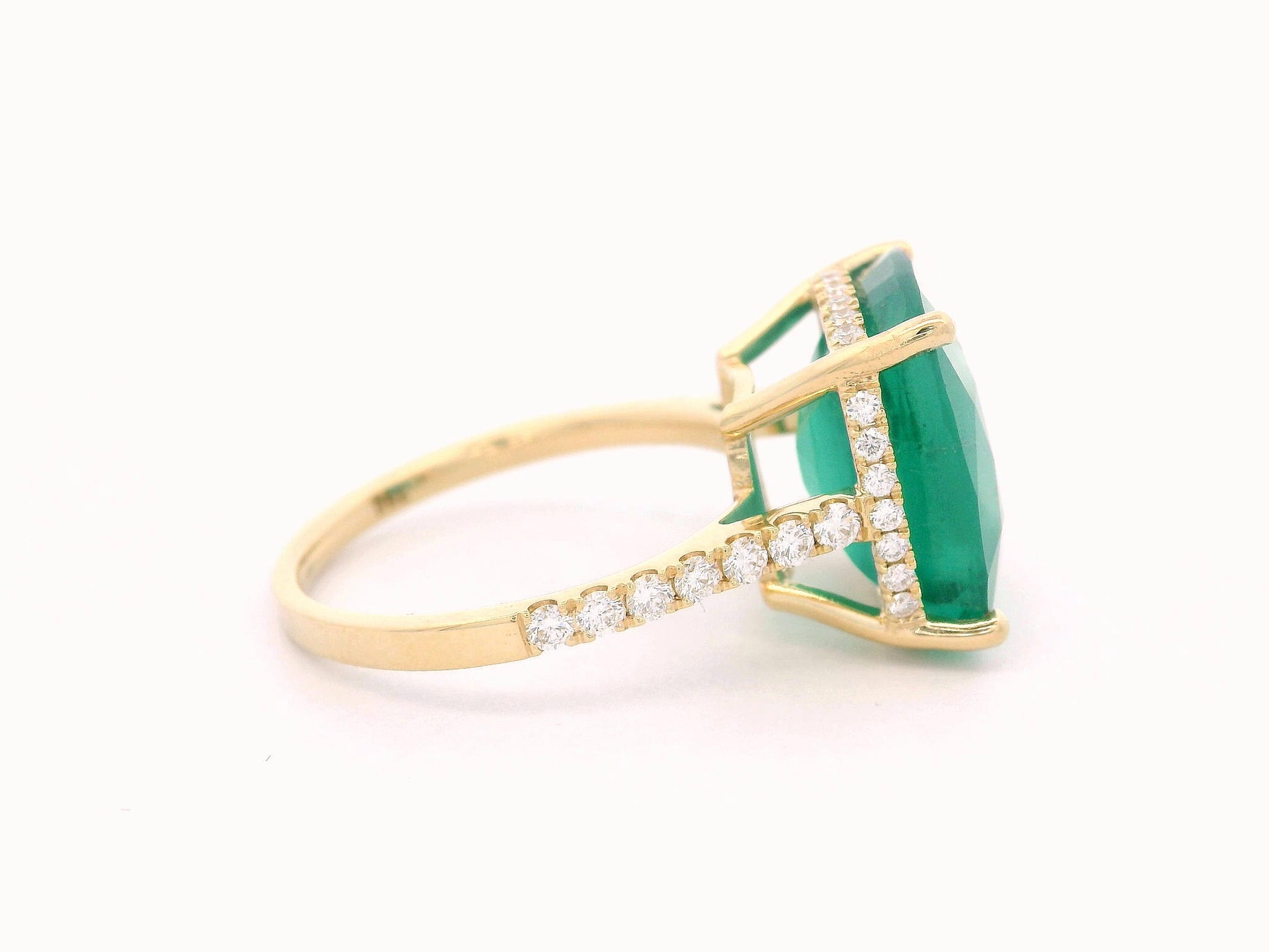 9.01 carat cushion-cut emerald ring in 18K yellow gold with hidden halo and diamond pavé band