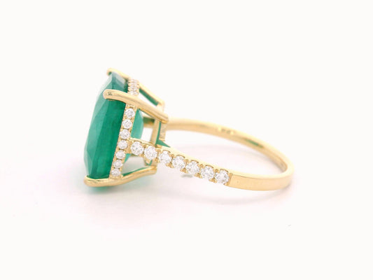 9.01 carat cushion-cut emerald ring in 18K yellow gold with hidden halo and diamond pavé band