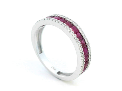 18K gold ruby and diamond ring with 1.36ct baguette-cut rubies and 0.26ct round diamonds in modern channel setting.