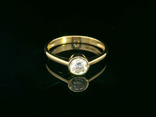 18K yellow gold solitaire ring with 0.51 carat round diamond in bezel setting