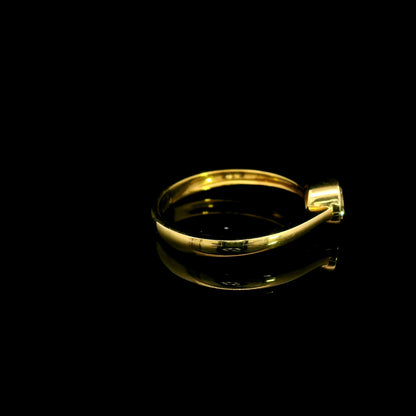 Round brilliant bezel set diamond engagement ring in 18K yellow gold with a slender solitaire band.