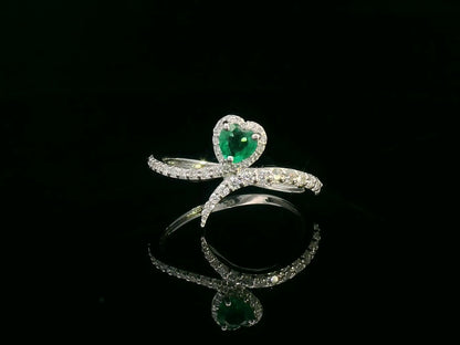 Heart-shaped emerald bypass ring in 18K white gold with diamond halo

