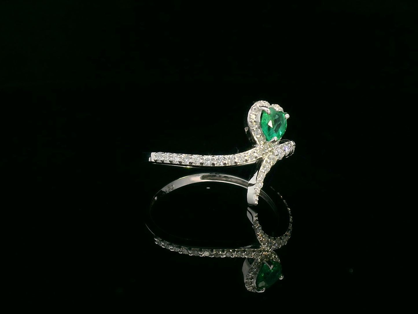 Heart-shaped emerald bypass ring in 18K white gold with diamond halo

