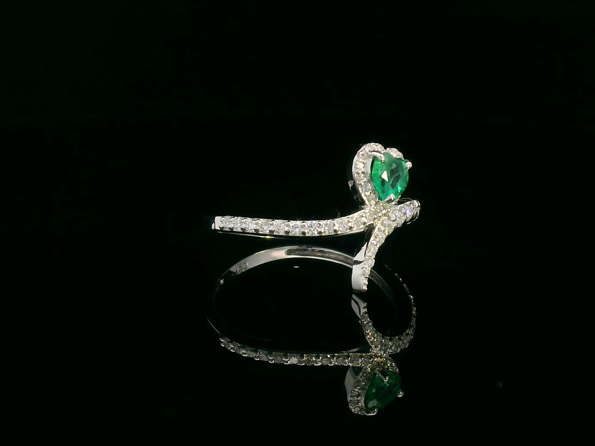 Heart-shaped emerald bypass ring in 18K white gold with diamond halo

