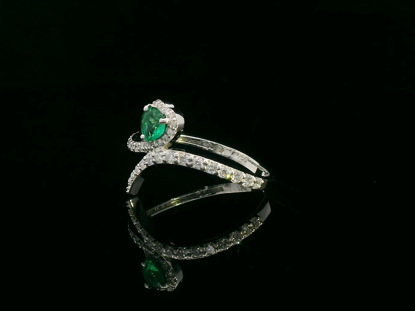 Heart-shaped emerald bypass ring in 18K white gold with diamond halo

