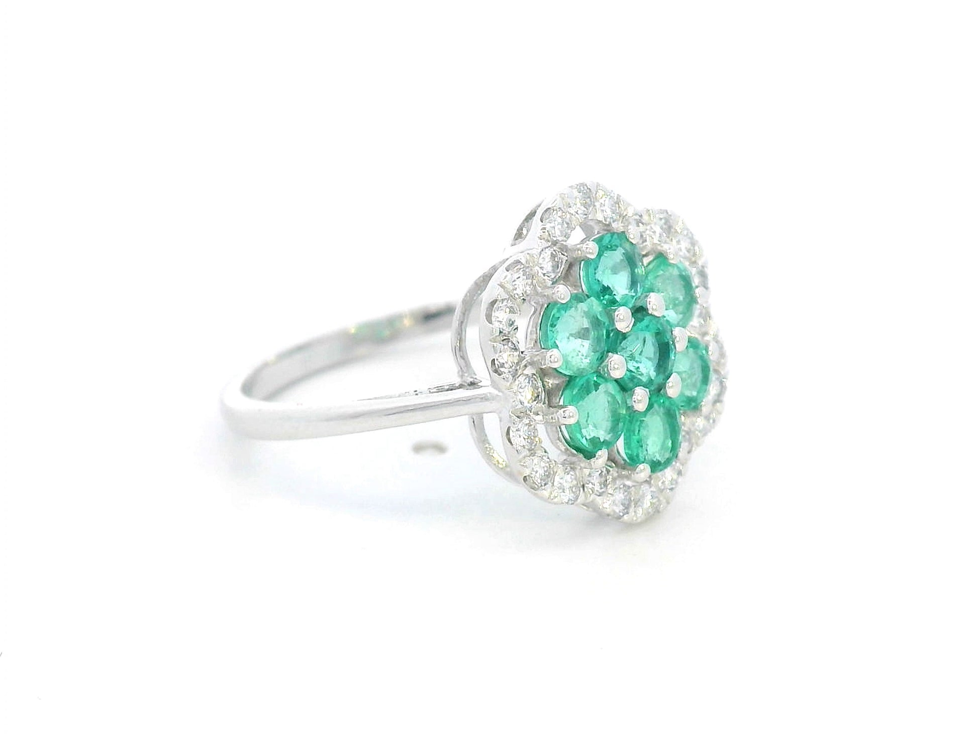 Floral emerald cluster and diamond halo ring in 18K gold

