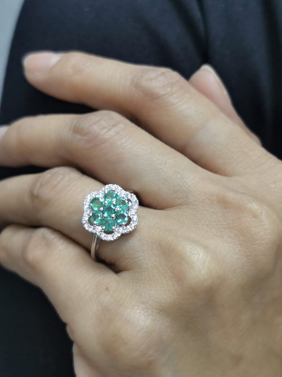 Floral emerald cluster and diamond halo ring in 18K gold

