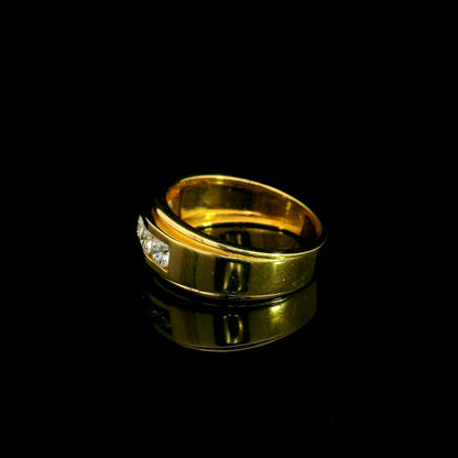 Yellow gold diamond band ring with channel set round diamonds and broad polished gold edges