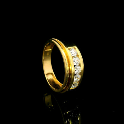 Yellow gold diamond band ring with channel set round diamonds and broad polished gold edges