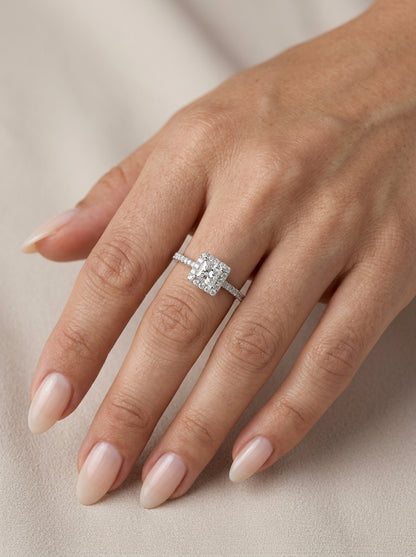 Princess cut diamond halo engagement ring in 18K white gold with a square diamond halo and diamond-set band.
