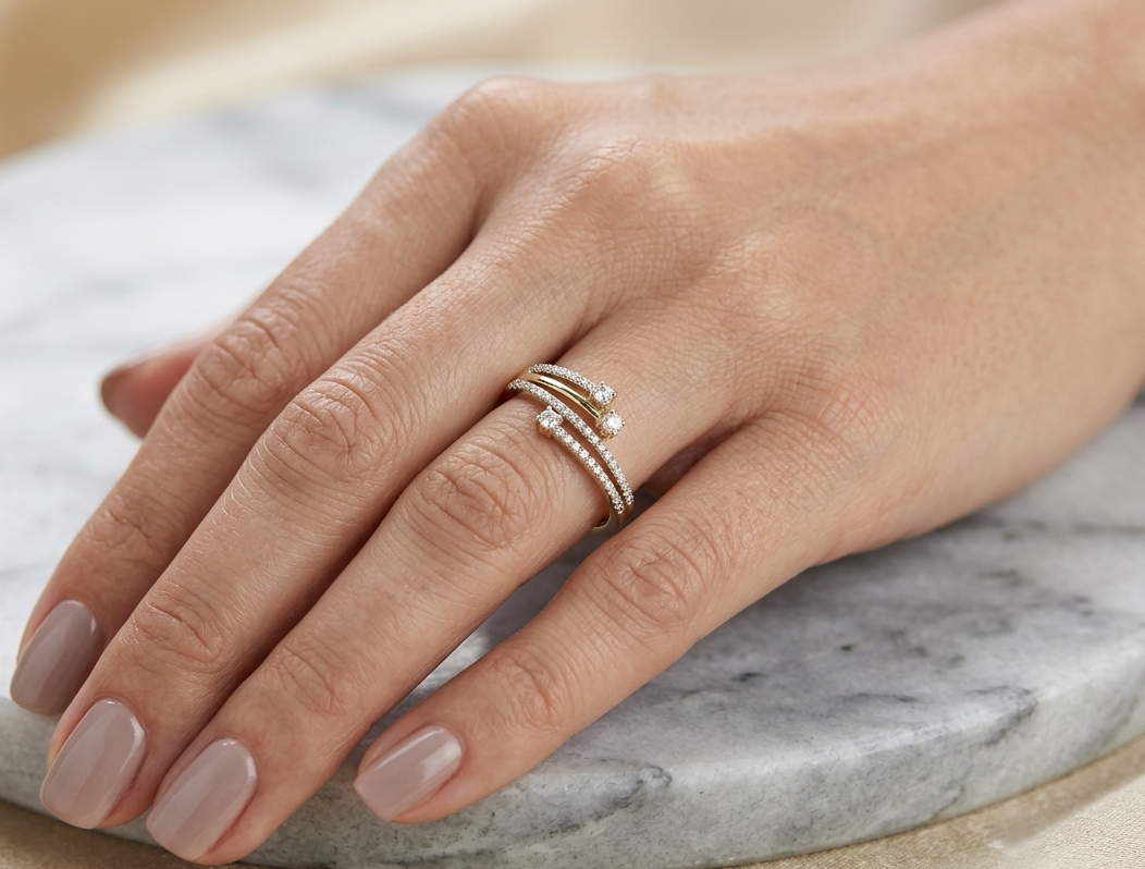 18K yellow gold open diamond wrap ring featuring three round brilliant diamonds and pavé-set natural diamonds with a total diamond weight of 0.31 carats.