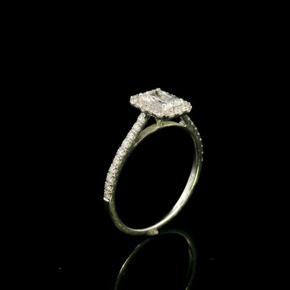 Emerald cut diamond halo bridal set in 18K white gold with a diamond engagement ring and matching wedding band.