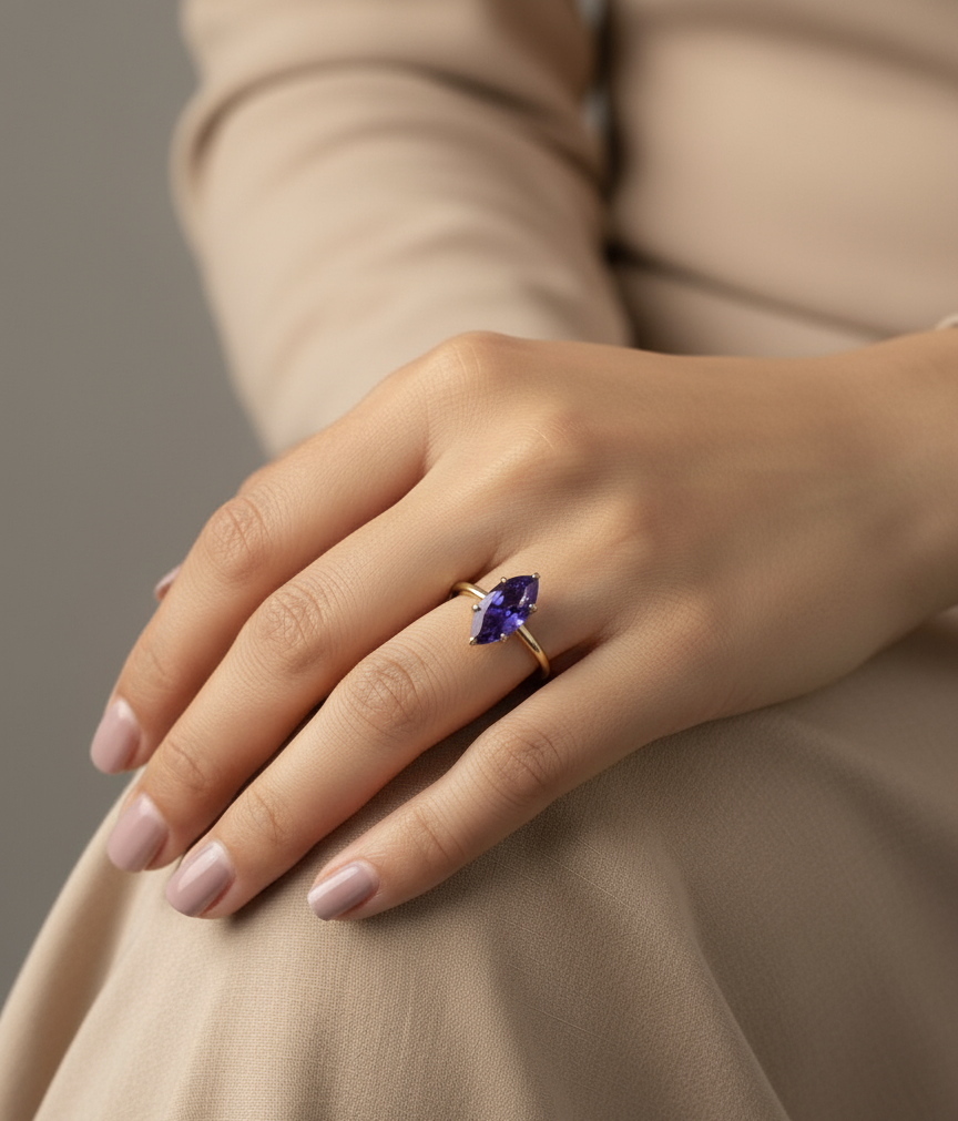 Marquise-cut tanzanite ring in 18K yellow gold with diamond accents – Emirates Diamonds