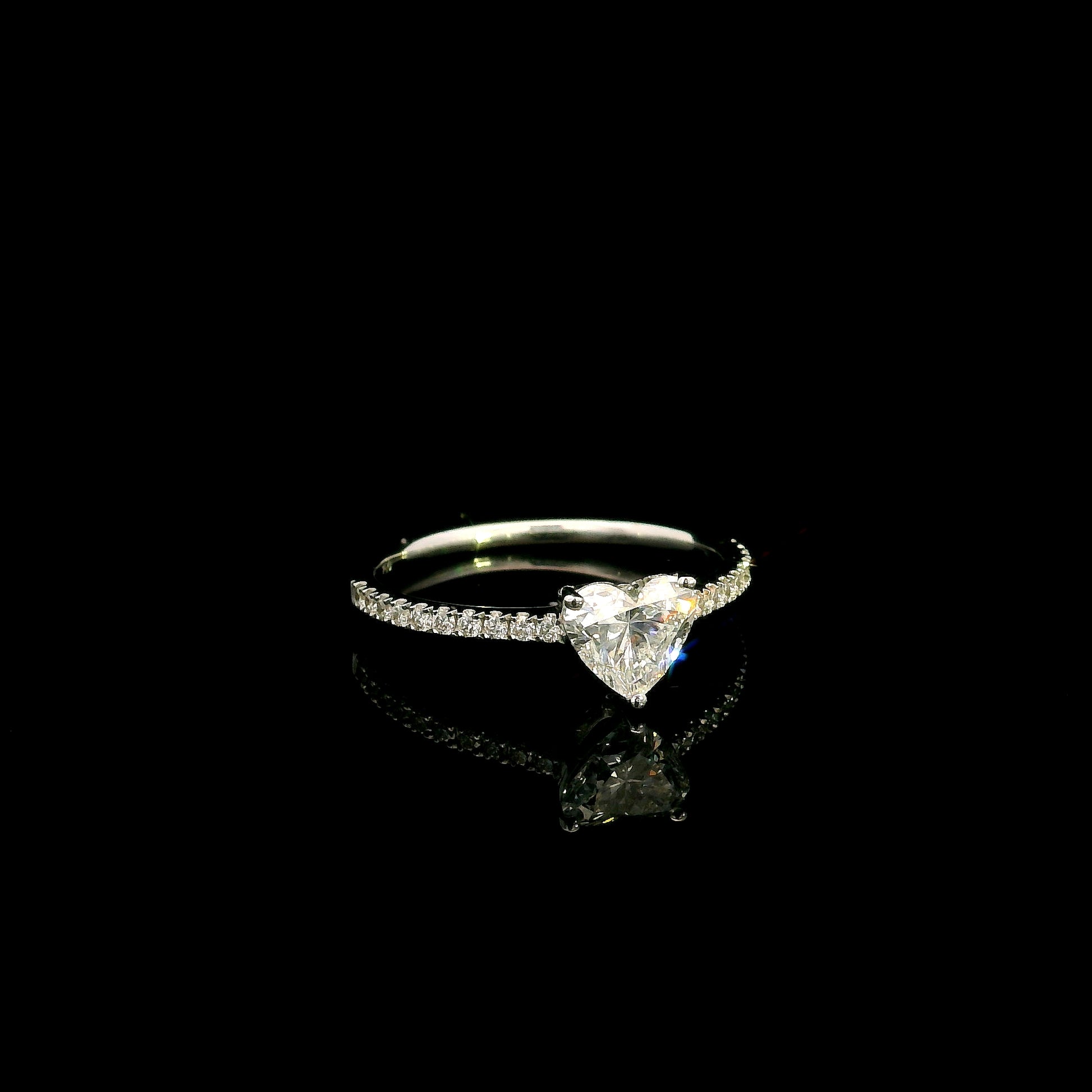 18K white gold heart shaped diamond engagement ring featuring a 0.90 carat IGI certified natural heart diamond with a pavé diamond band.