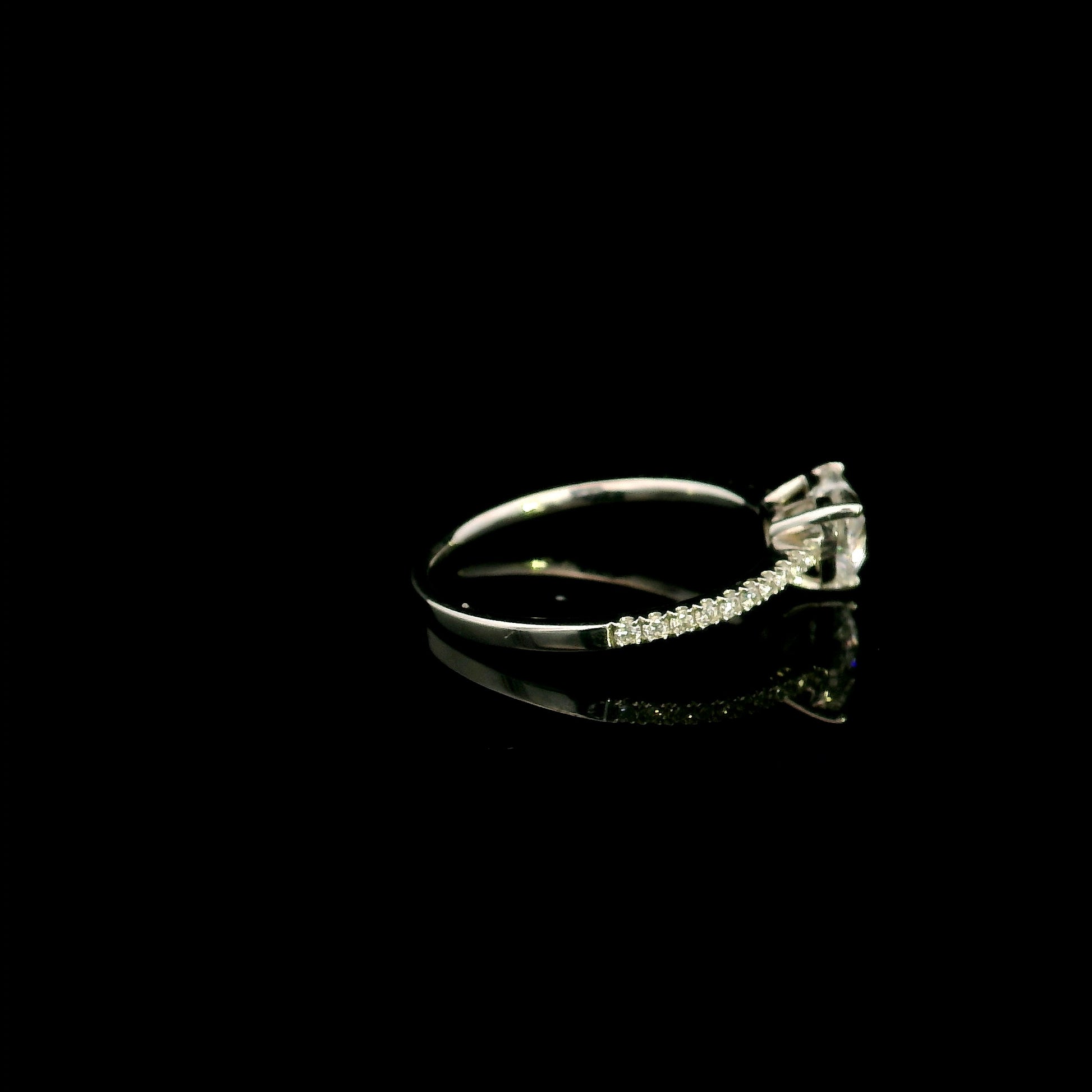 18K white gold heart shaped diamond engagement ring featuring a 0.90 carat IGI certified natural heart diamond with a pavé diamond band.