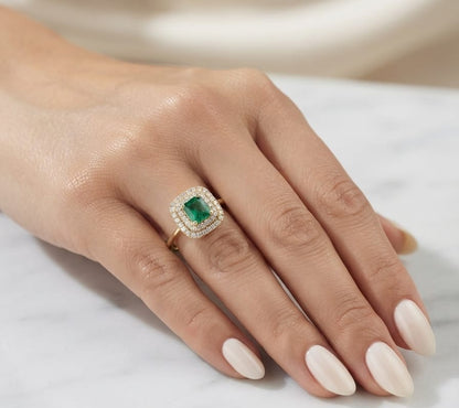 Emerald halo ring with square-cut natural emerald, double diamond halo and 18K yellow gold band.