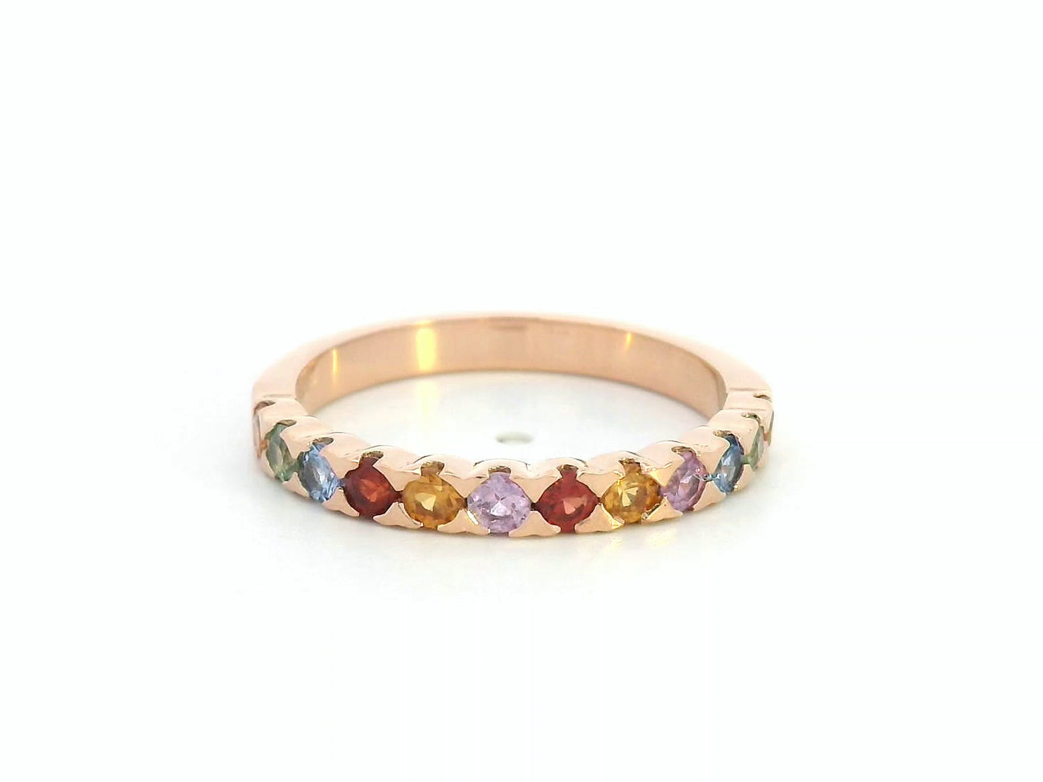 18K rose gold ring set with 0.93 carats of multicolored round sapphires in a half band design

