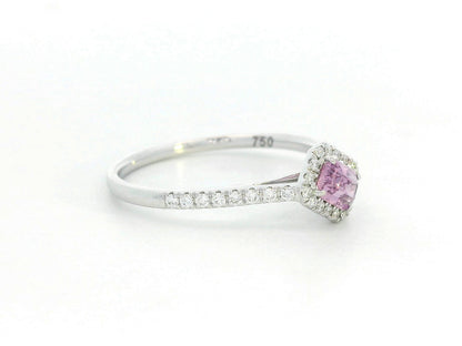 Ring with a pink gemstone and diamond accents on a white background