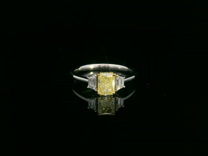 18K white gold ring with radiant-cut Fancy Yellow Diamond and trapezoid-cut side diamonds
