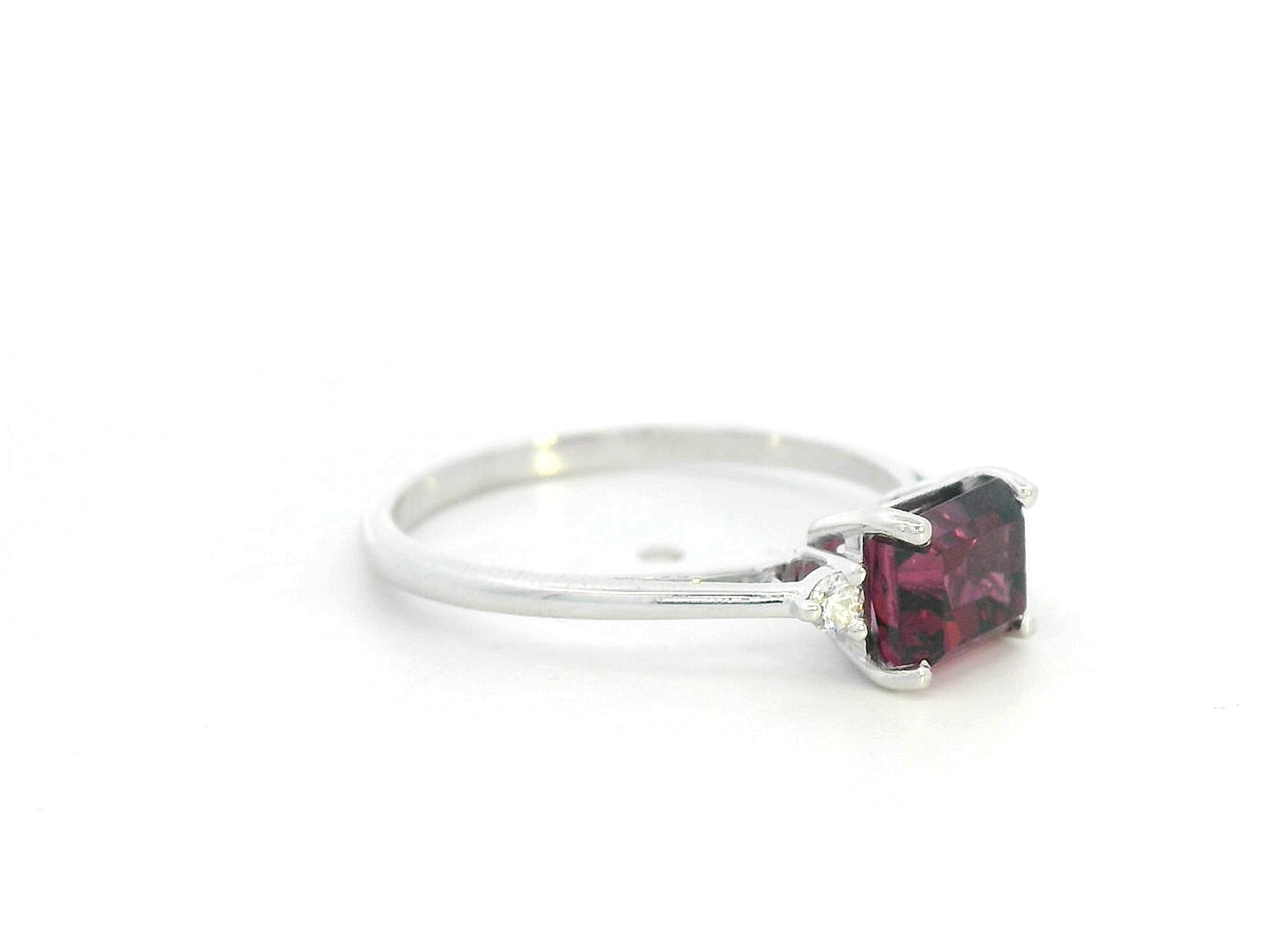 Emerald-cut Rhodolite three-stone ring in white gold