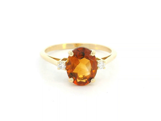 Oval citrine ring with diamond accents in 18K yellow gold