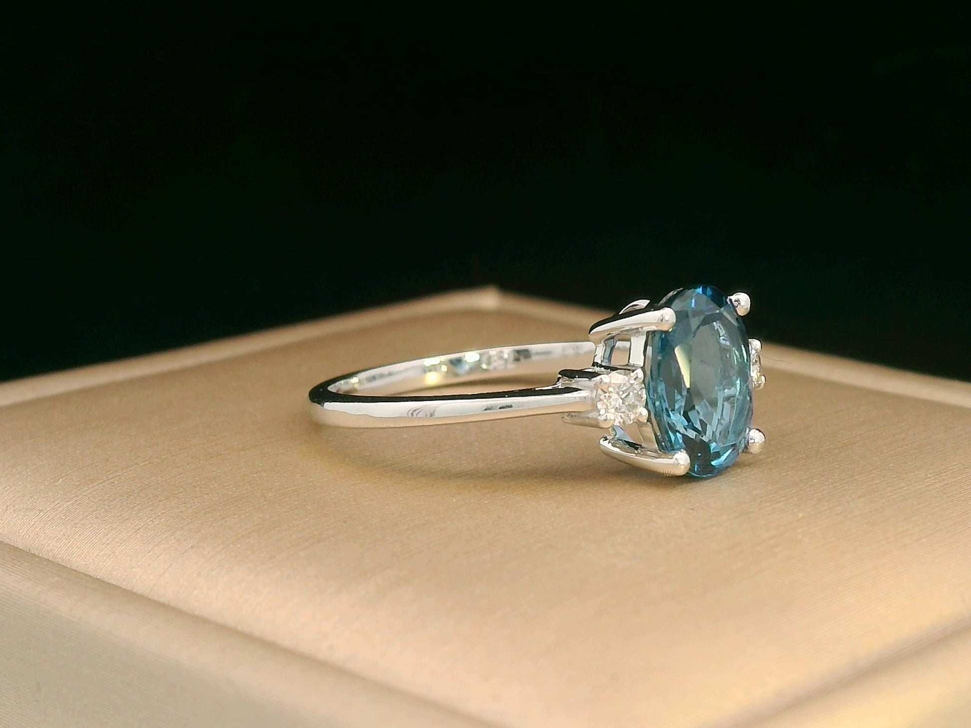 Elegant gemstone ring with oval-cut topaz and diamond accents