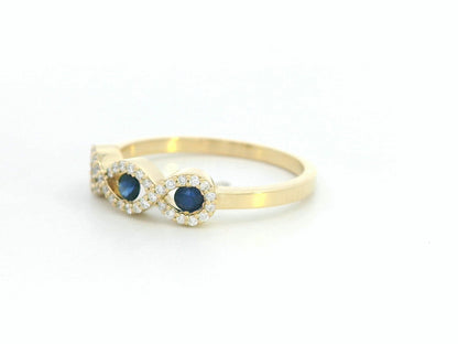 Luxury women’s ring with 0.27ct sapphires and 0.12ct diamonds in gold infinity setting