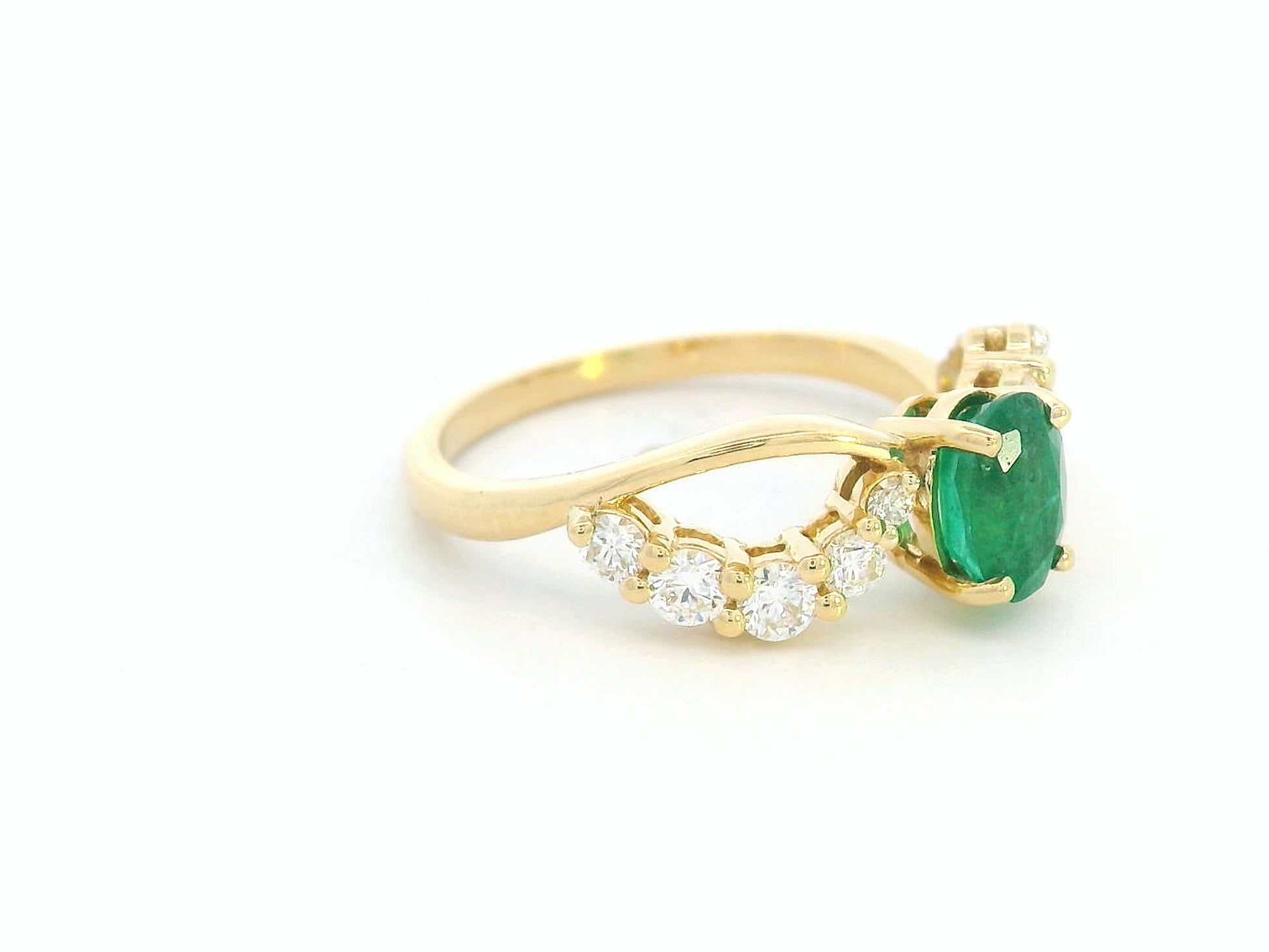 Split shank emerald ring with diamonds in 18K yellow gold