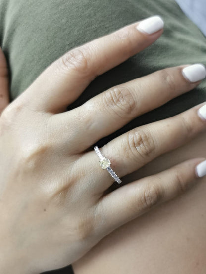 White gold ring with cushion yellow diamond and side diamonds
