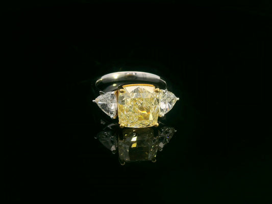 Cushion-cut Fancy Yellow diamond ring with trillion side diamonds