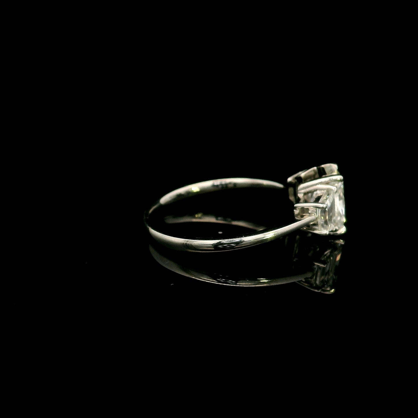 18K white gold radiant cut diamond engagement ring with a 1.51 carat HRD certified centre diamond and trapezoid side diamonds.