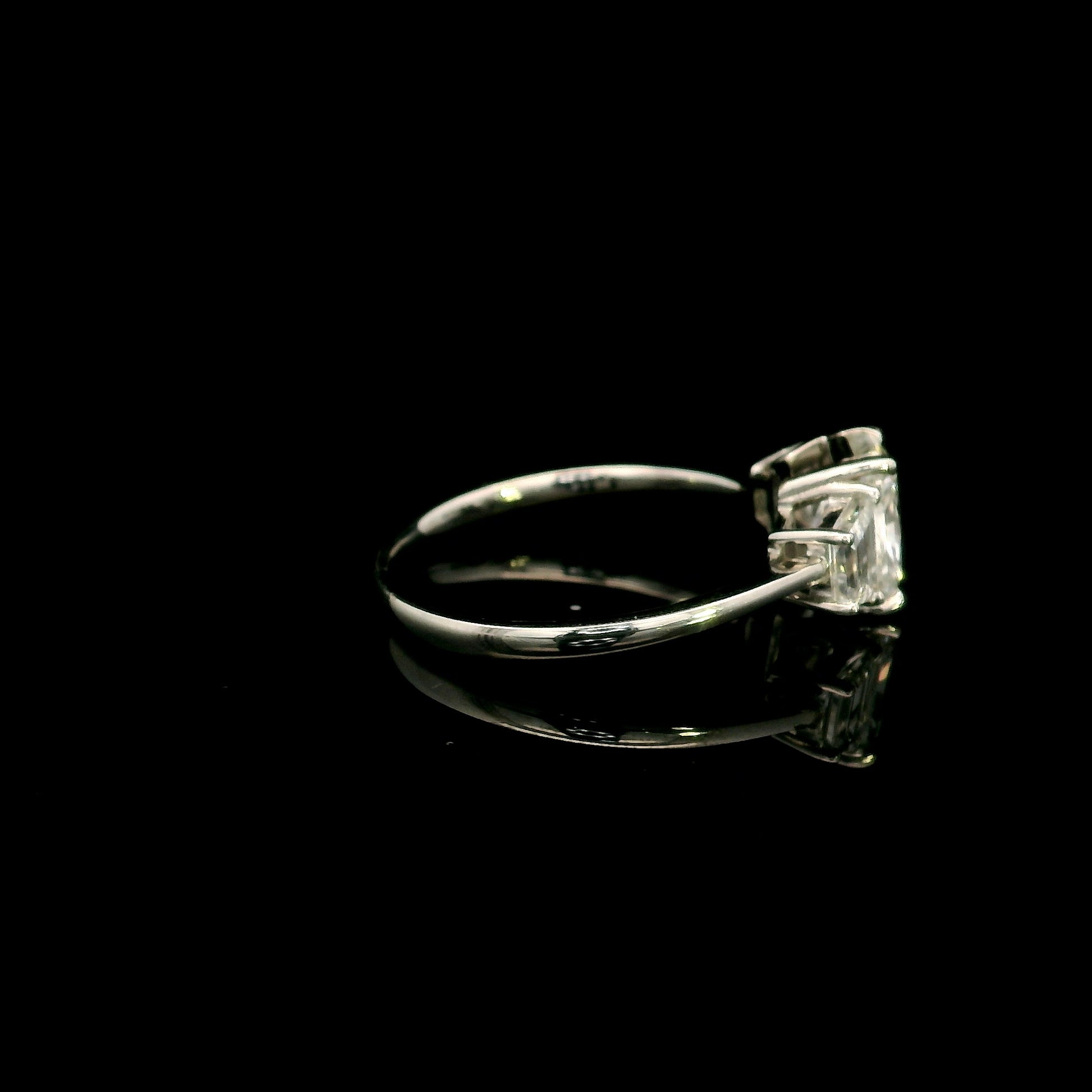 18K white gold radiant cut diamond engagement ring with a 1.51 carat HRD certified centre diamond and trapezoid side diamonds.
