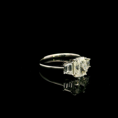 18K white gold radiant cut diamond engagement ring with a 1.51 carat HRD certified centre diamond and trapezoid side diamonds.
